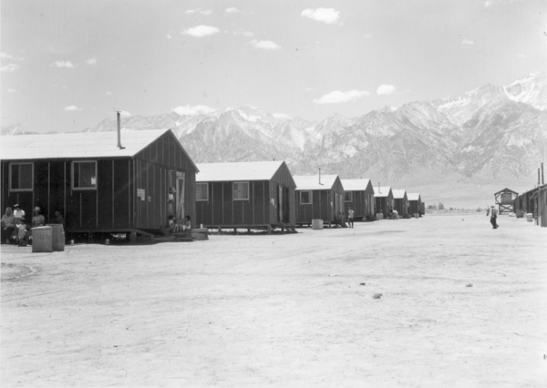 Barrack row looking west to the desert and mountains beyond (July 2, 1942) Courtesy Wikimedia and Dorothea Lange
