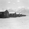 Barrack row looking west to the desert and mountains beyond (July 2, 1942)  Courtesy Wikimedia and Dorothea Lange