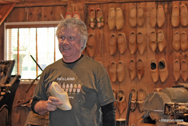 A craftsman shows how clogs are made on a century-old machine. In a few minutes the shoe is finished