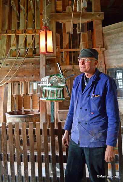 A miller explains to visitors how the windmill was used for industrial purposes