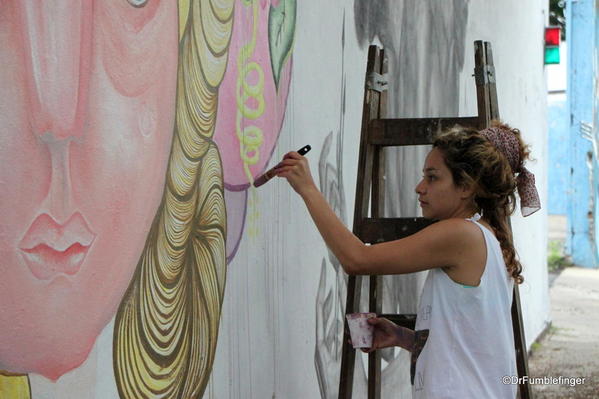 Artists creating street art on Charcarita walls.