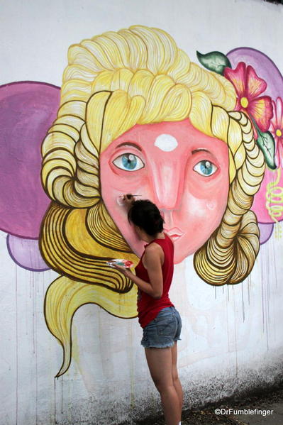 Artists creating street art on Charcarita walls.