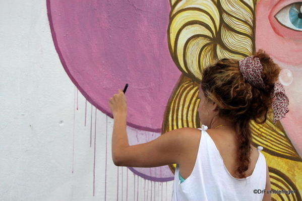 Artists creating street art on Charcarita walls.